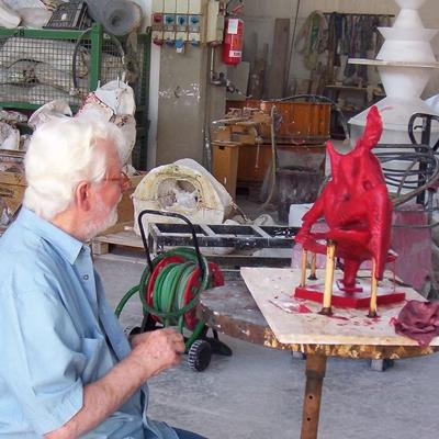 Il maestro Jorio Vivarelli durante una fase di lavoro di una scultura in cera da fondere in bronzo.